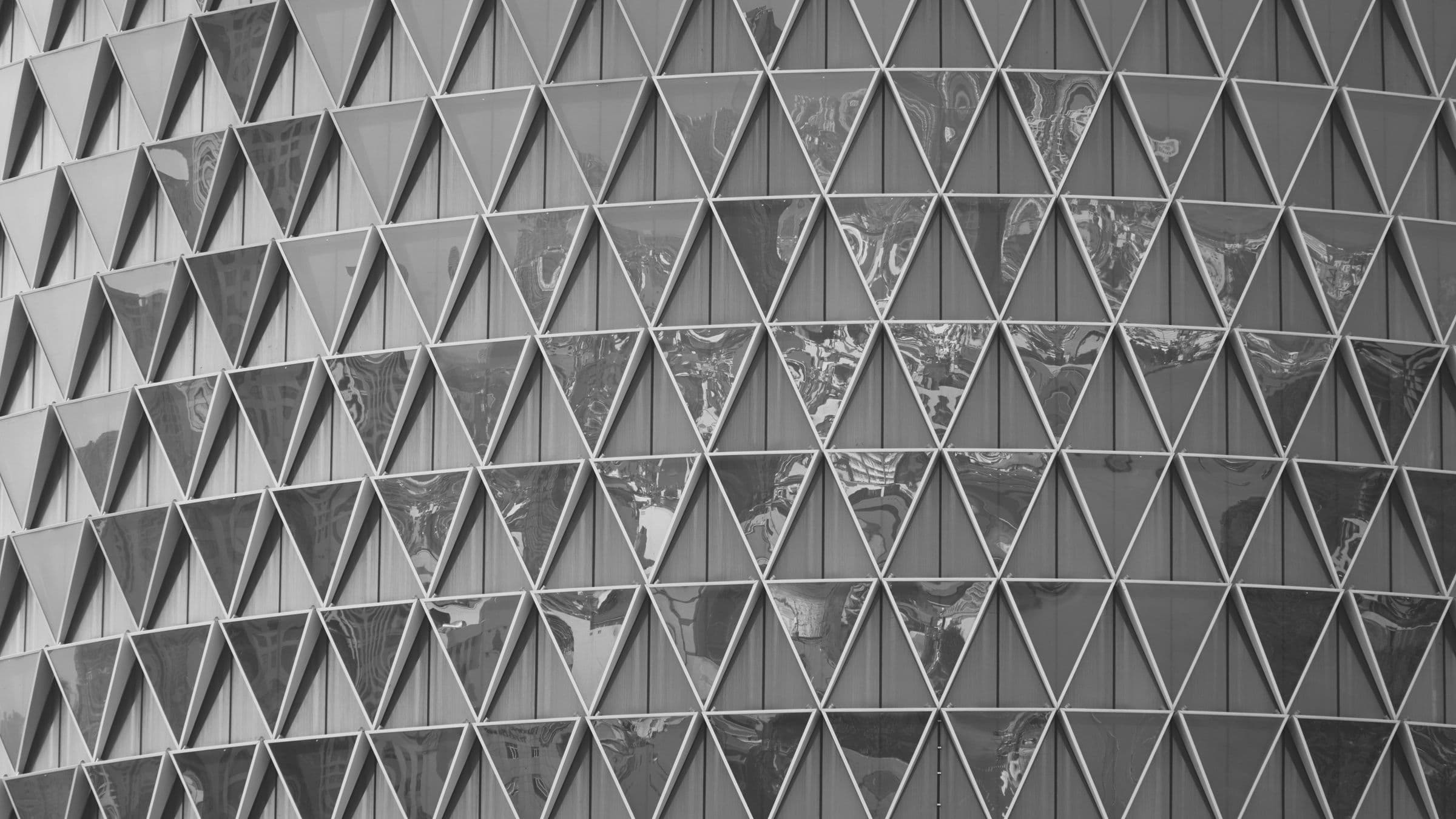 Black-and-white triangular glass facade geometry.